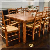 F72. Framhouse style dining table with 8 rush seat ladderback chairs. 